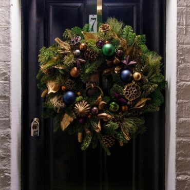 A festive composite door styled for Christmas, offering warmth, security, and seasonal charm